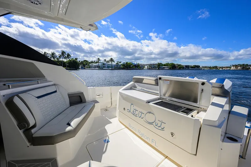 Slide: The Image of 2022 Tiara Yachts 43 LE with seating and grill, docked in Boca Raton, Florida. - 2