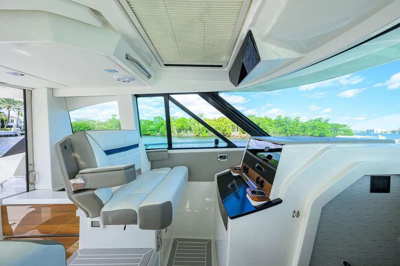 Slide: The Image of 2022 Tiara Yachts 43 LE interior with modern helm and scenic water view. - 31
