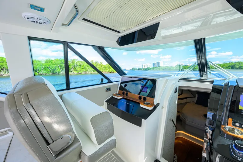 Slide: The Image of 2022 Tiara Yachts 43 LE interior with modern helm and scenic water view. - 32