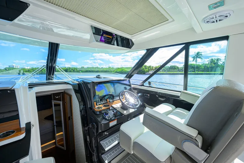 Slide: The Image of 2022 Tiara Yachts 43 LE helm with modern navigation system and panoramic water views. - 34