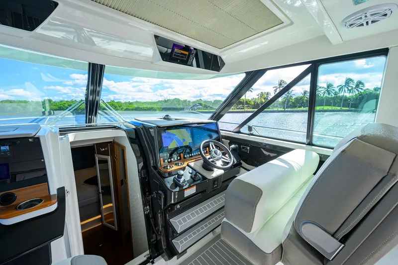 Slide: The Image of Interior of 2022 Tiara Yachts 43 LE, featuring modern helm and scenic water view. - 35