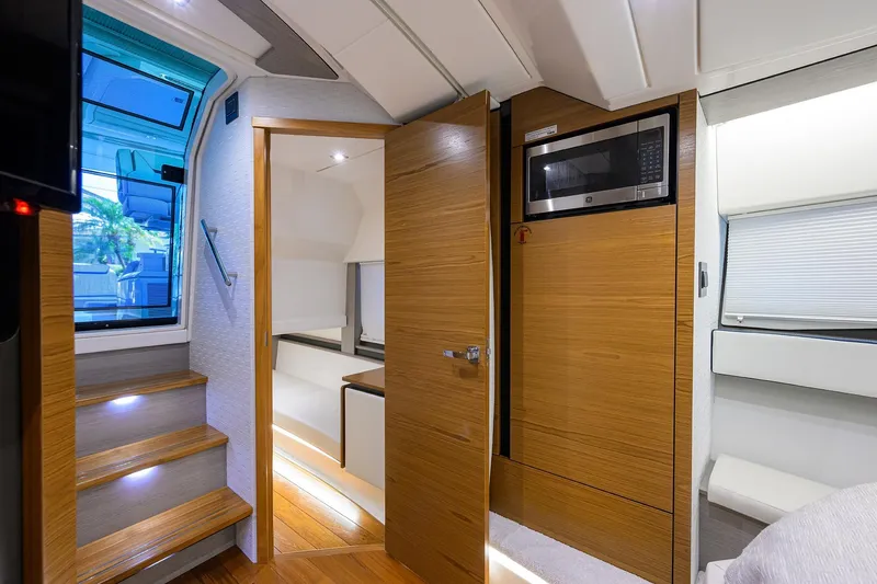 Slide: The Image of Interior of 2022 Tiara Yachts 43 LE, featuring wooden cabinetry and modern amenities. - 39