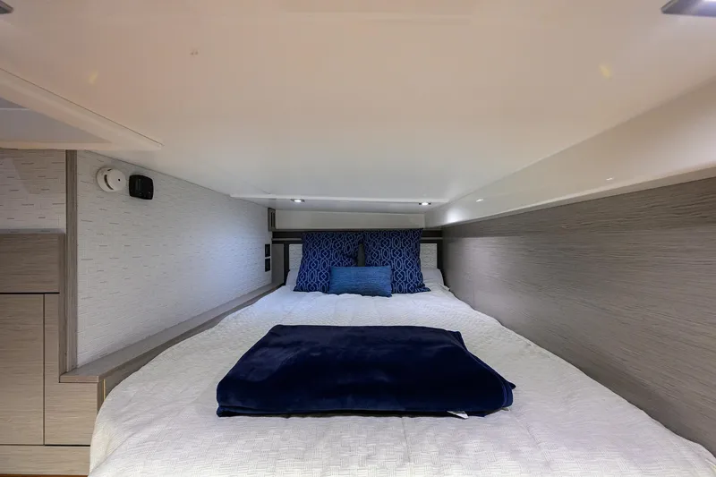 Slide: The Image of Luxurious cabin interior of 2022 Tiara Yachts 43 LE with plush bedding. - 46