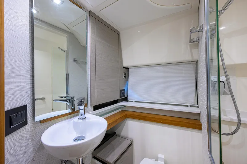 Slide: The Image of Modern bathroom interior of 2022 Tiara Yachts 43 LE, featuring sleek sink and mirror. - 48