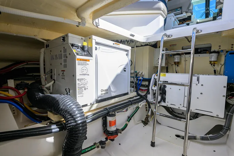 Slide: The Image of Engine room of 2022 Tiara Yachts 43 LE, featuring Onan Marine generator and equipment. - 51