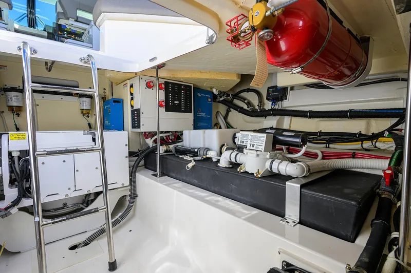 Slide: The Image of Engine room of 2022 Tiara Yachts 43 LE with equipment and fire extinguisher. - 52