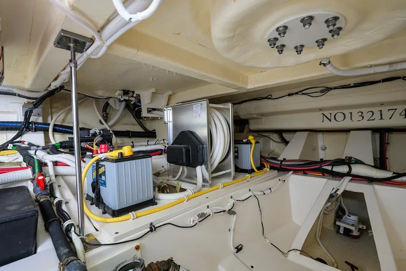 Slide: The Image of Engine room of 2022 Tiara Yachts 43 LE, showcasing wiring and battery systems. - 55