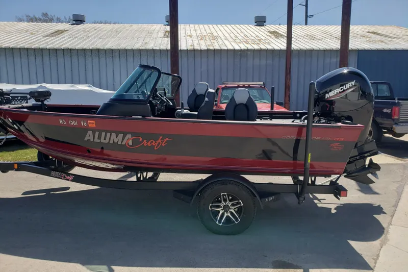 The Image of 2023 Alumacraft Competitor 175 Sport boat with Mercury engine on trailer. - 0