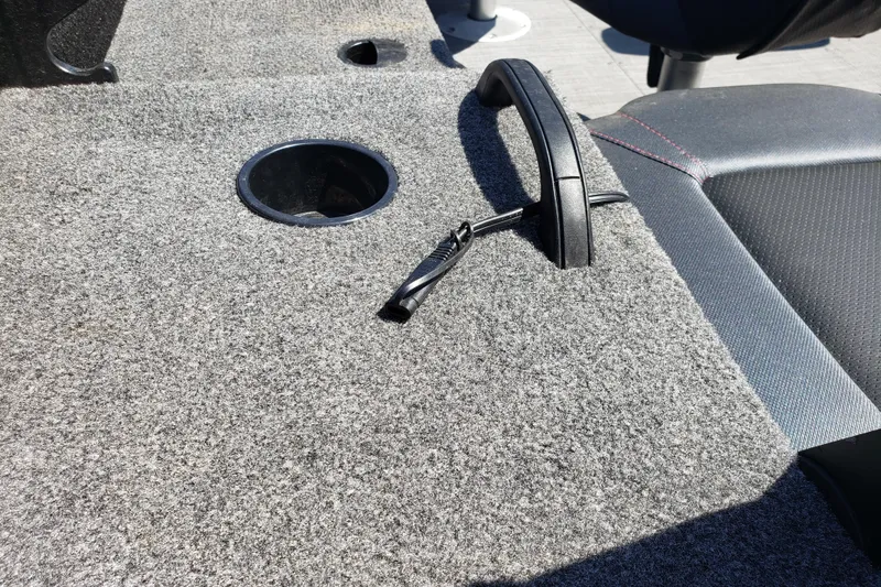 Slide: The Image of 2023 Alumacraft Competitor 175 Sport boat interior with carpeted surface and cup holder. - 11