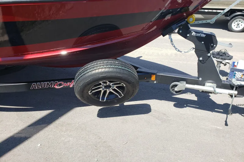 Slide: The Image of 2023 Alumacraft Competitor 175 Sport boat trailer with tire and hitch detail. - 12