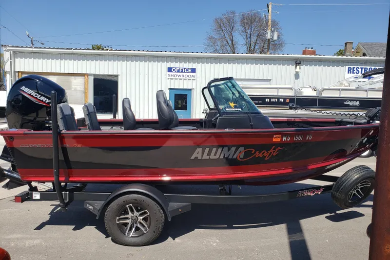 Slide: The Image of 2023 Alumacraft Competitor 175 Sport boat with Mercury engine, parked outside showroom. - 2