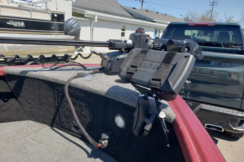 Slide: The Image of 2023 Alumacraft Competitor 175 Sport boat with mounted equipment and nearby truck. - 3