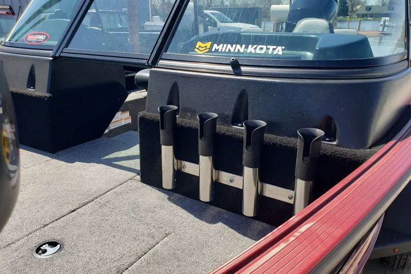 Slide: The Image of 2023 Alumacraft Competitor 175 Sport boat interior with rod holders and Minn Kota branding. - 6