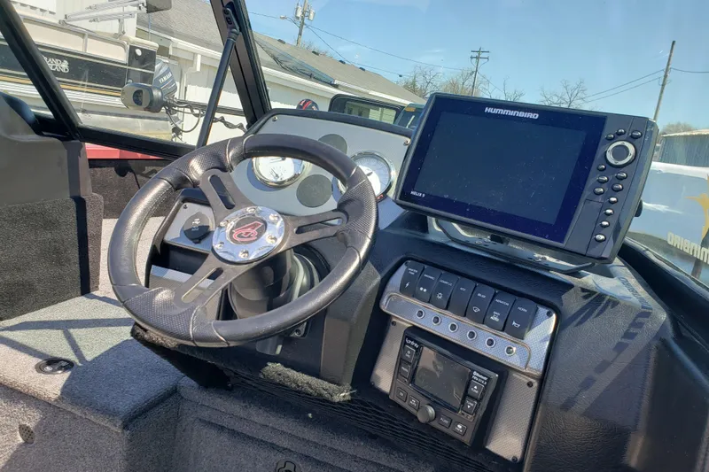 Slide: The Image of 2023 Alumacraft Competitor 175 Sport dashboard with steering wheel and Humminbird electronics. - 9