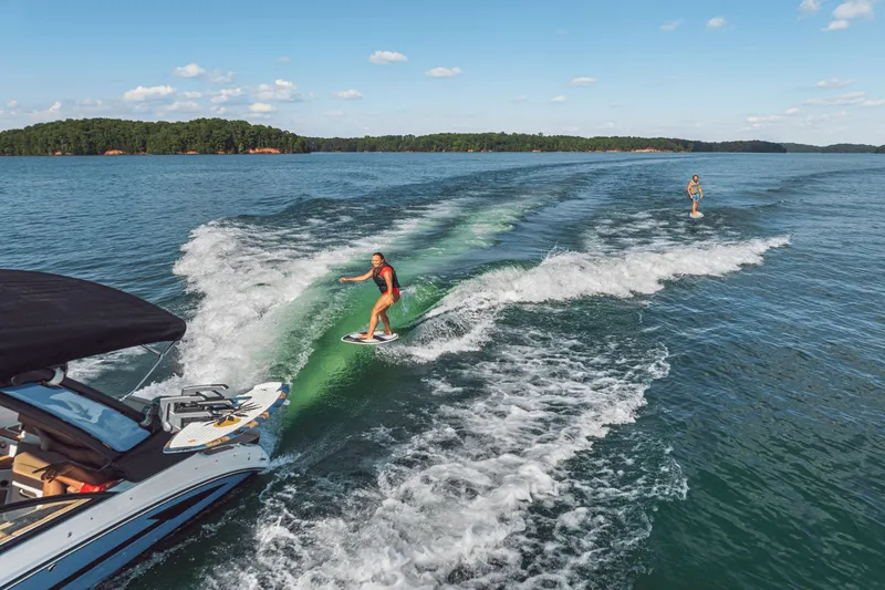 Slide: The Image of Surfer behind Sea Ray SDX 250 Surf boat on lake. - 12