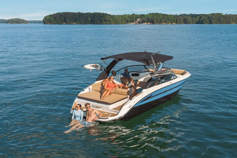 Slide: The Image of 2026 Sea Ray SDX 250 Surf boat on a tranquil lake. - 15