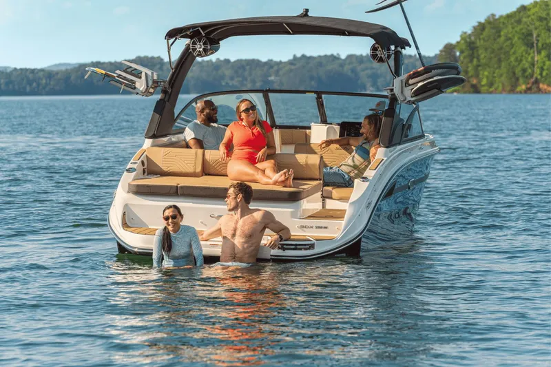 Slide: The Image of People relaxing on a 2026 Sea Ray SDX 250 Surf boat. - 16