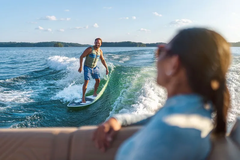 Slide: The Image of Man surfing behind Sea Ray SDX 250 Surf 2026 on lake. - 31