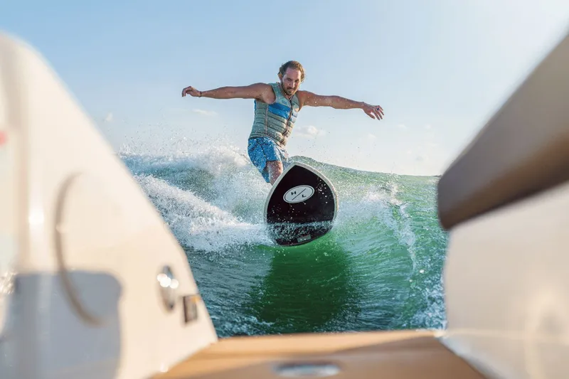 Slide: The Image of Surfer riding wave behind Sea Ray SDX 250 Surf 2026. - 32