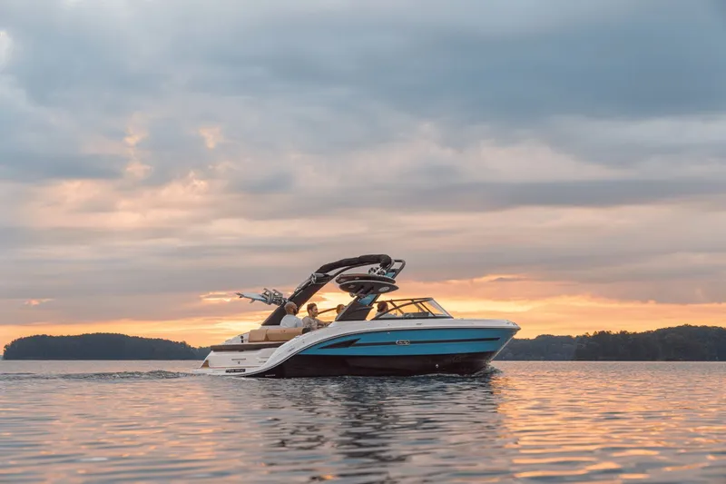Slide: The Image of 2026 Sea Ray SDX 250 Surf cruising at sunset on the water. - 34