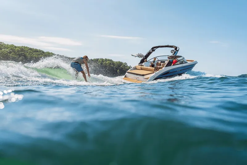 Slide: The Image of 2026 Sea Ray SDX 250 Surf with surfer riding wave. - 4