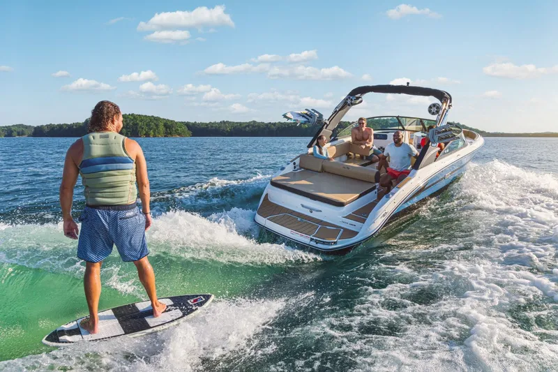 Slide: The Image of Man surfing behind Sea Ray SDX 250 Surf boat, 2026 model. - 6