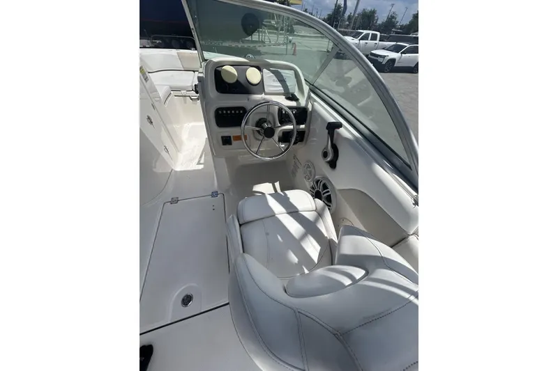 Slide: The Image of 2014 Robalo R207 Dual Console boat interior with steering wheel and seating. - 11