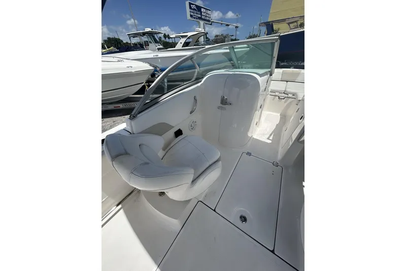 Slide: The Image of 2014 Robalo R207 Dual Console boat interior with white seating and storage compartments. - 12