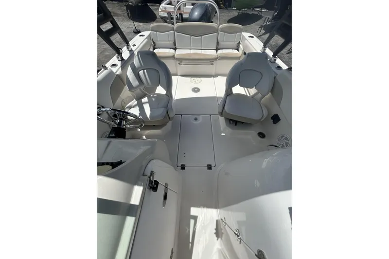 Slide: The Image of 2014 Robalo R207 Dual Console boat interior with seating and steering wheel. - 13
