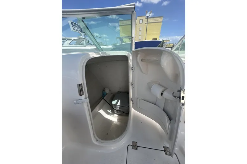 Slide: The Image of 2014 Robalo R207 Dual Console boat interior storage compartment with open door. - 14