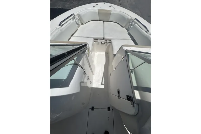 Slide: The Image of 2014 Robalo R207 Dual Console boat interior with seating and open windshield. - 16