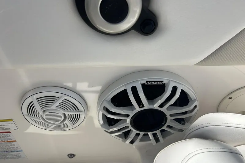 Slide: The Image of Speakers on a 2014 Robalo R207 Dual Console boat interior. - 18