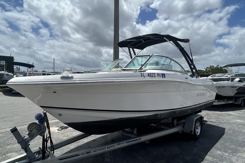 Slide: The Image of 2014 Robalo R207 Dual Console boat on trailer under cloudy sky. - 3