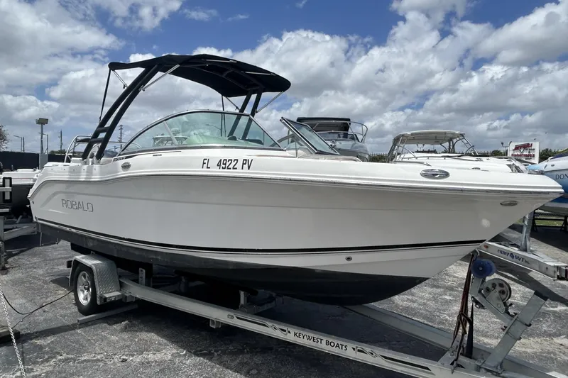 Slide: The Image of 2014 Robalo R207 Dual Console boat on trailer under cloudy sky. - 4
