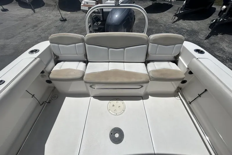 Slide: The Image of 2014 Robalo R207 Dual Console boat interior with cushioned seating and storage. - 9