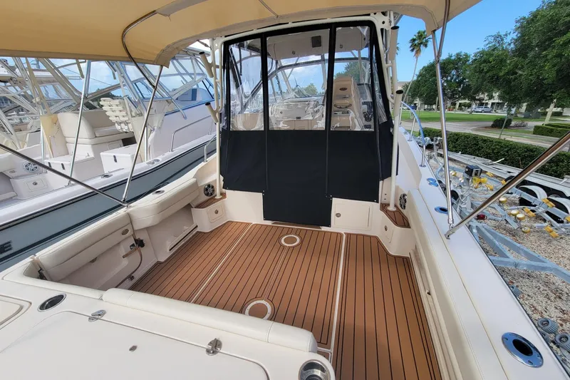 Slide: The Image of 2023 Grady-White Marlin 300 boat interior with teak flooring and canopy. - 10