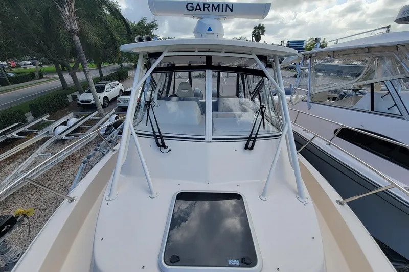 Slide: The Image of 2023 Grady-White Marlin 300 boat with Garmin radar, docked alongside other vessels. - 15