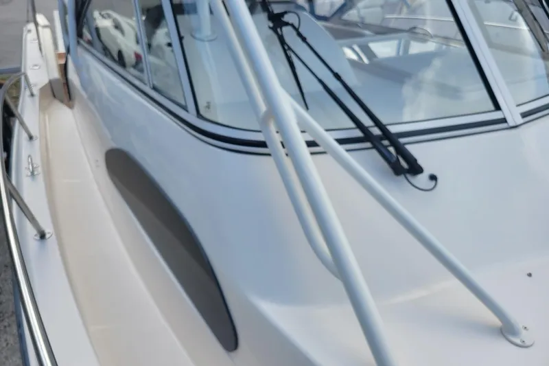 Slide: The Image of 2023 Grady-White Marlin 300 boat exterior with sleek design and windshield wipers. - 16