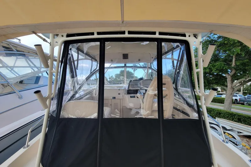 Slide: The Image of 2023 Grady-White Marlin 300 boat interior with clear enclosure and seating. - 18