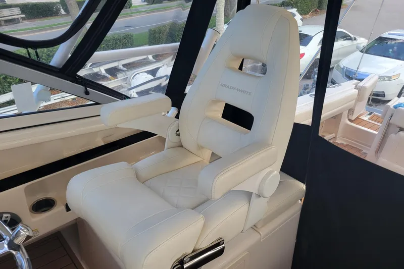 Slide: The Image of Captain's chair in 2023 Grady-White Marlin 300 boat, featuring luxurious white upholstery. - 20