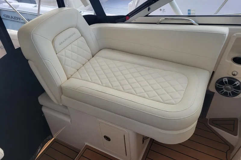 Slide: The Image of 2023 Grady-White Marlin 300 boat seat with quilted white upholstery. - 21