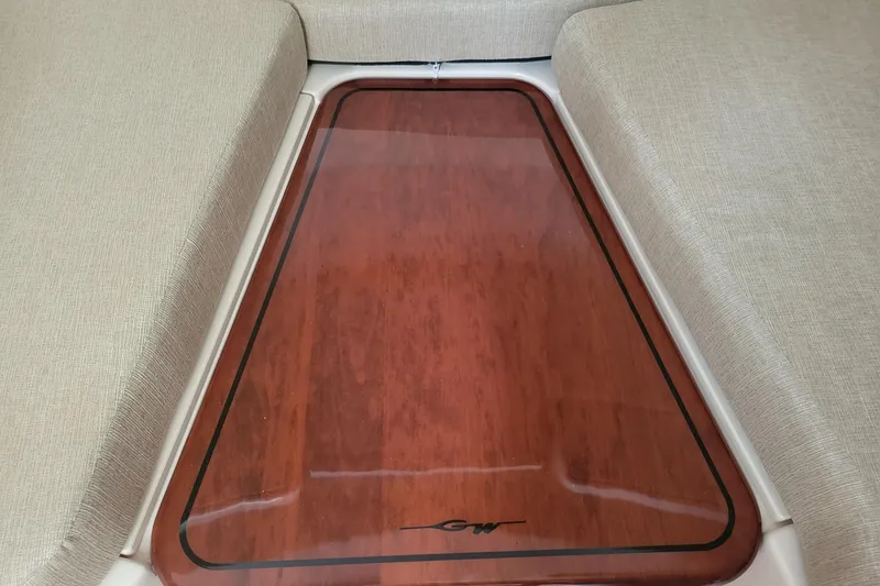 Slide: The Image of Interior view of 2023 Grady-White Marlin 300 boat with cushioned seating and wooden flooring. - 24