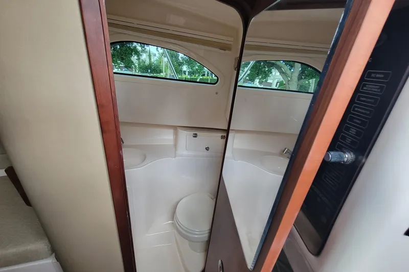 Slide: The Image of Interior of 2023 Grady-White Marlin 300 boat bathroom with modern amenities. - 28