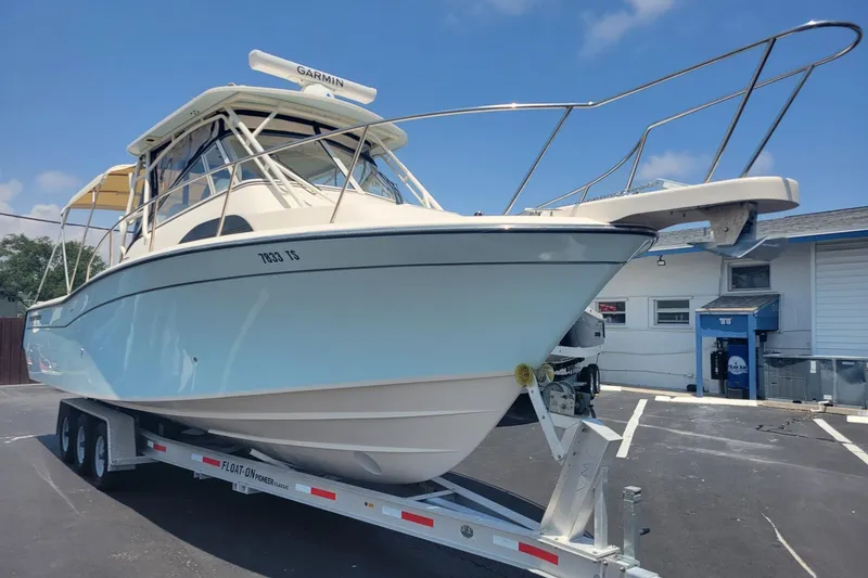 Slide: The Image of 2023 Grady-White Marlin 300 boat on trailer in parking lot. - 3