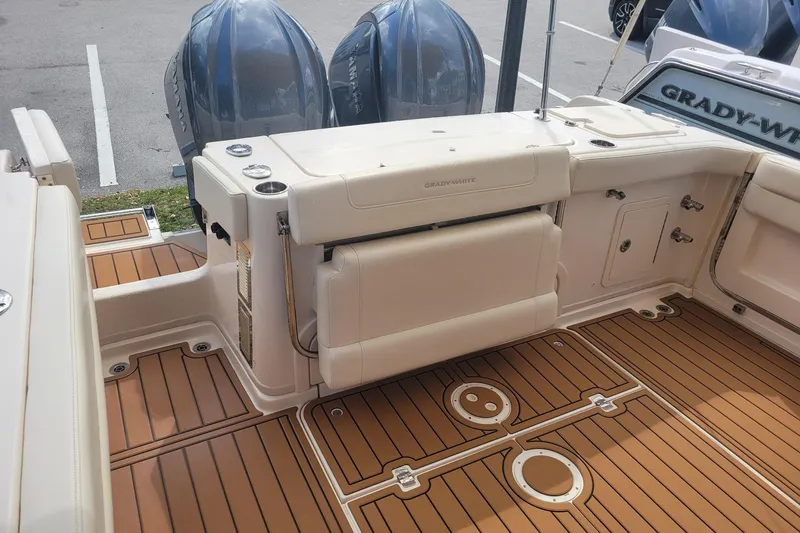 Slide: The Image of 2023 Grady-White Marlin 300 boat deck with twin Yamaha engines and teak flooring. - 6