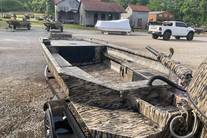 Slide: The Image of 2026 Excel 1651 Viper F4 boat with camouflage design in a rural setting. - 3