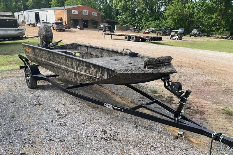 Slide: The Image of 2026 Excel 1651 Viper F4 boat on trailer, parked outdoors near a workshop. - 4
