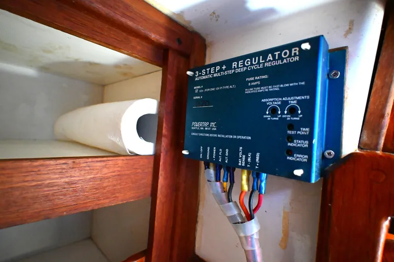 Slide: The Image of Electrical regulator in a 1980 Tartan 37 sailboat, mounted on a wooden interior panel. - 54