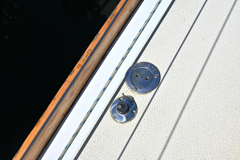 Slide: The Image of Deck fittings on a 1980 Tartan 37 sailboat, featuring a waste cap and textured surface. - 11