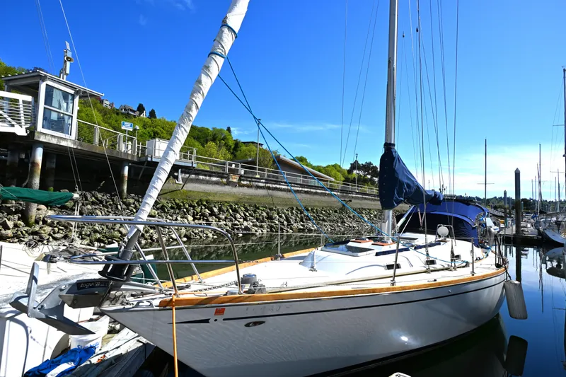 Slide: The Image of 1980 Tartan 37 sailboat docked in a marina under clear blue skies. - 2